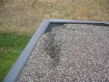 Flat roof repair addressing ponding and worn membrane